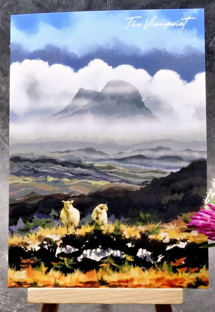 Larger Image titled The Viewpoint, showing an A6 size greetings card, blank inside, on a small easel depicting an atmospheric landscape scene from a well known Assynt viewpoint on the B869.