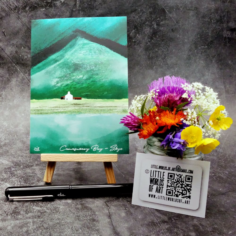 Image titled Camasunary Bay showing an A6 size greetings card, blank inside, on a small easel depicting a view of an isolated house with Bla Bheinn in the background on the Isle of Skye.