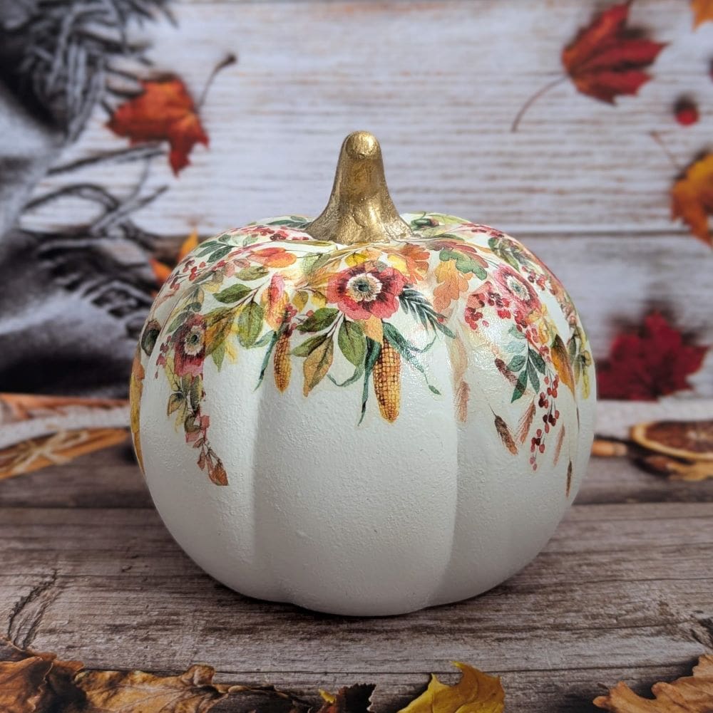 White ceramic 16.5cm pumpkin decoupaged with an Autumn leaves design and finished with a gold leaf stalk.