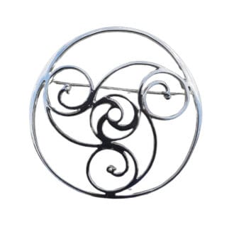 Sterling silver brooch in a round thick wire shape, inside the outer ring, three spirals interlocking in the middle forming another small circle. A duck face is at the end of each spiral. The brooch is set on a white background