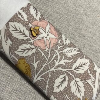 Soft brown and pink floral lined padded fabric glasses case with little wooden bee decoration