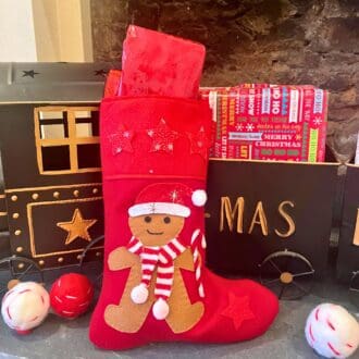 Handmade Christmas Stocking with a felt gingerbread wearing a hat and scarf to keep warm