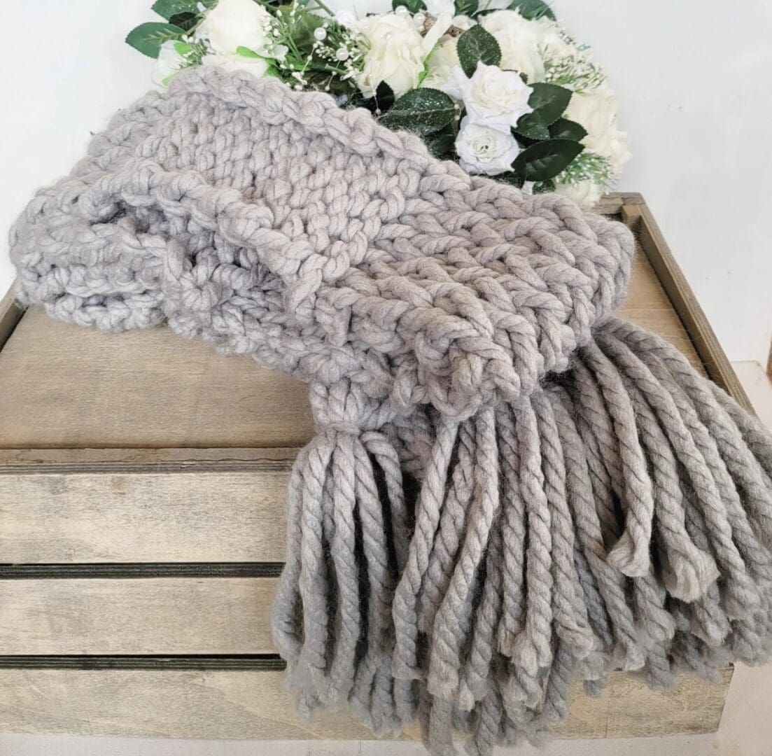 Grey chunky knit scarf with large grey tassels