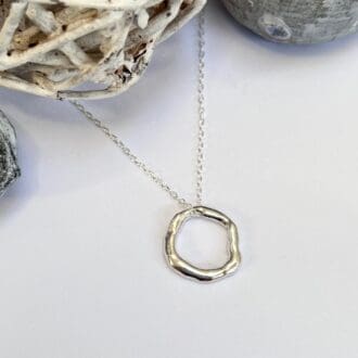 Organic silver circle necklace made from molten silver