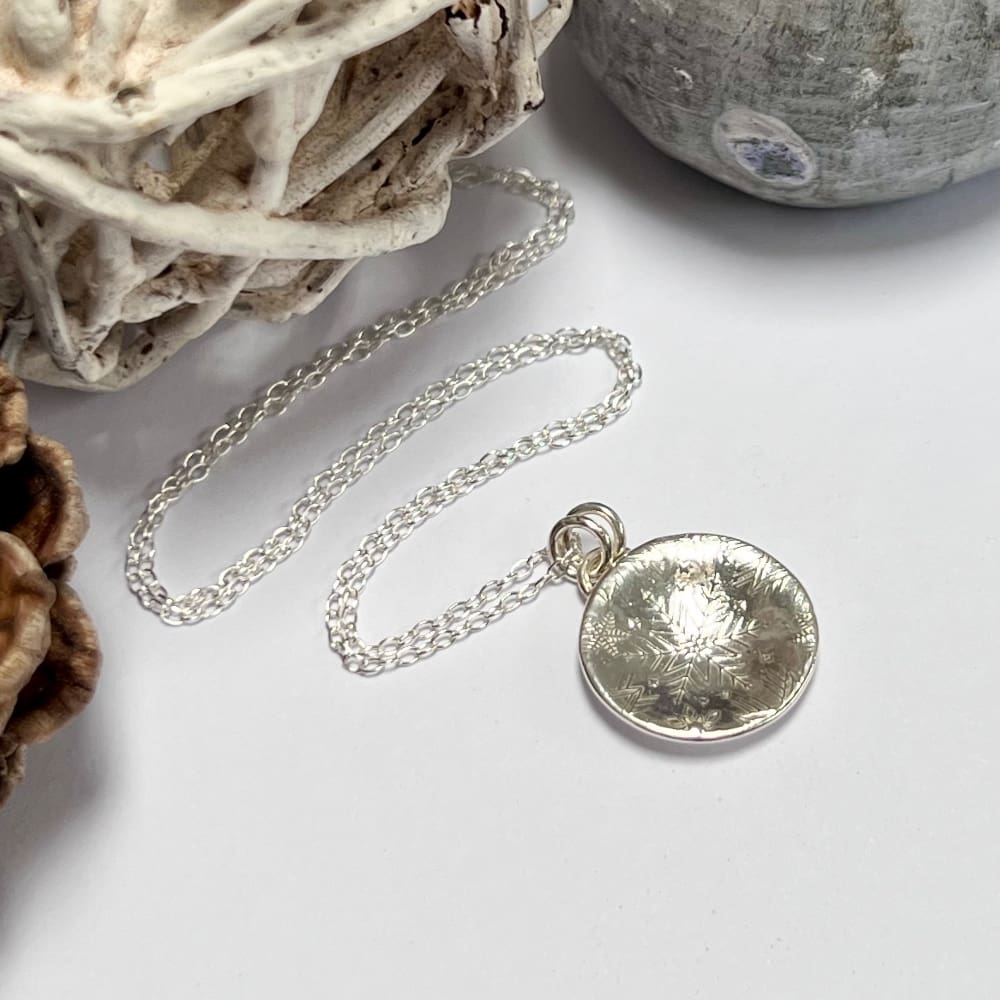 Handmade silver dome necklace with snowflake textured pattern