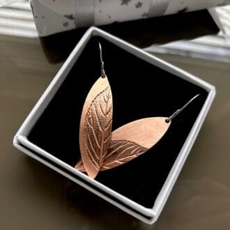 Copper drop earrings with sterling silver ear wires and a leaf impressions set on each earring, presented in a small with gift box.