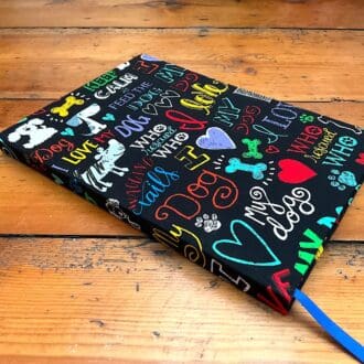 Hard cover handmade notebook filled with lined paper covered in dog fabric