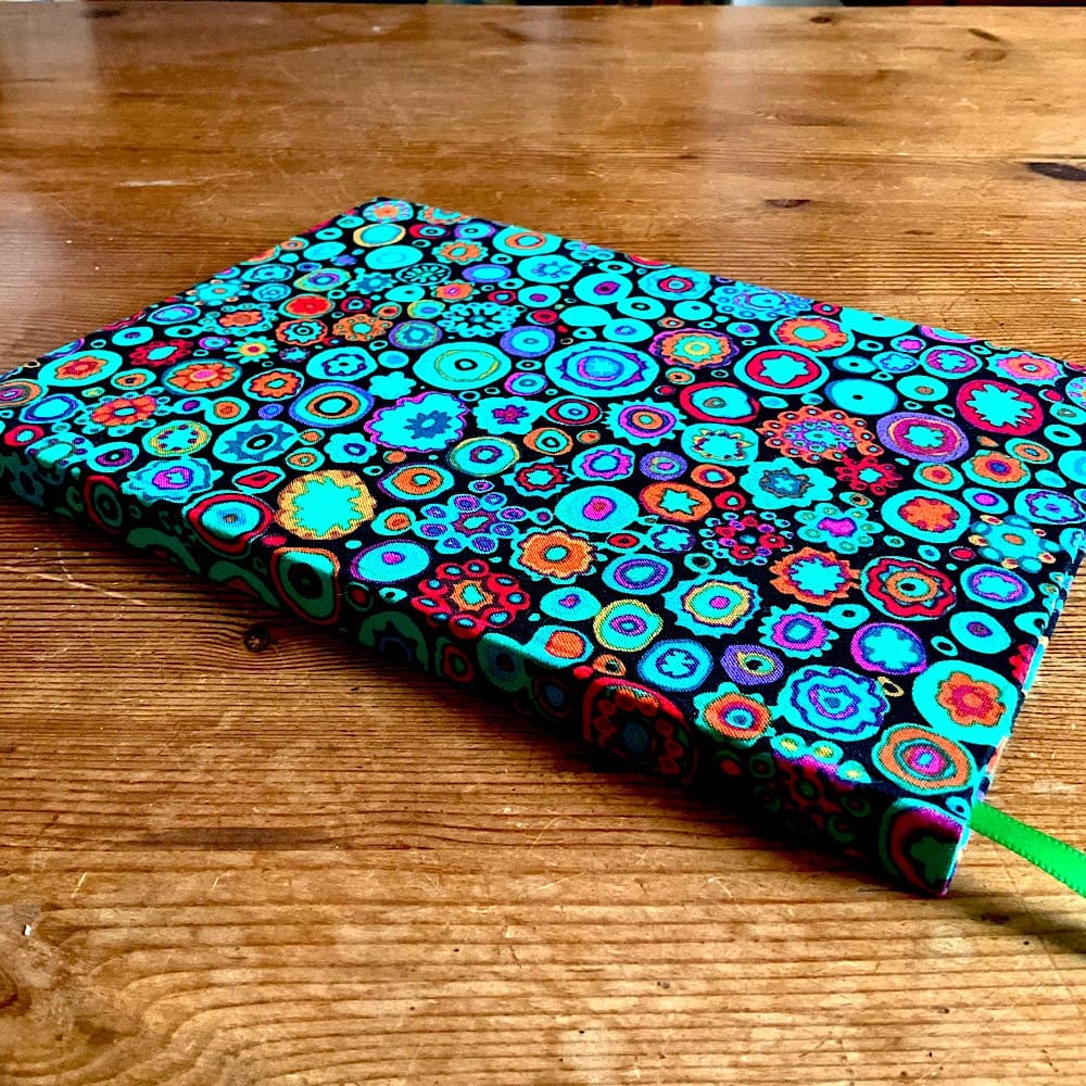 A5 handmade notebook covered in Kaffe Fassett Paperweight Fabric