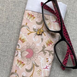 Peach and pink floral fabric glasses case with wooden bee decoration