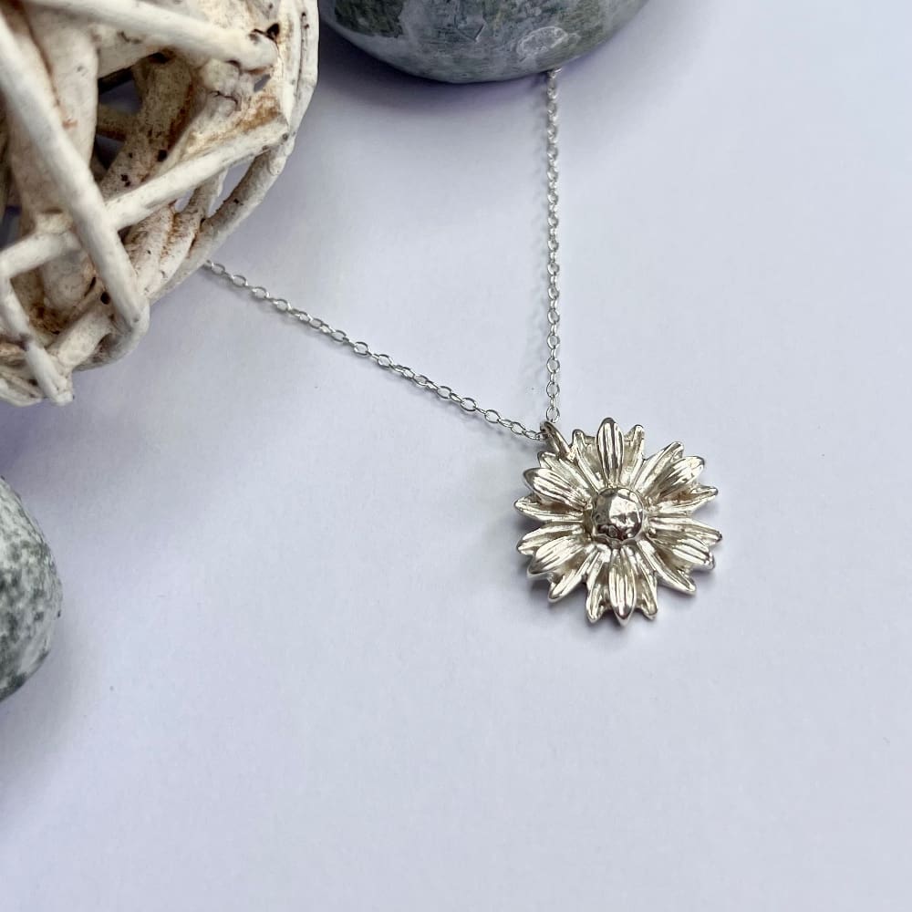 Detailed silver daisy necklace made from recycled silver