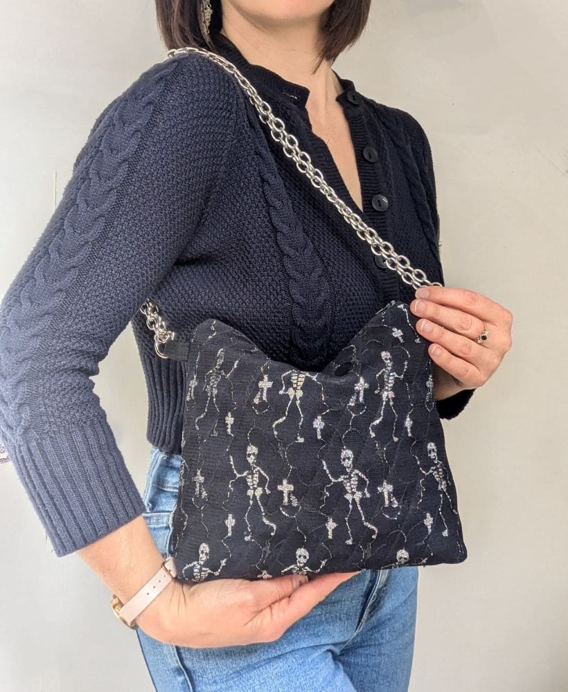 A woman modelling a halloween style shoulder bag