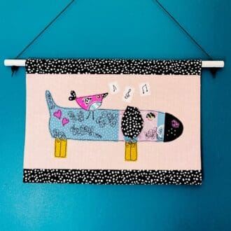 Sausage dog and singing bird textile wall hanging decoration