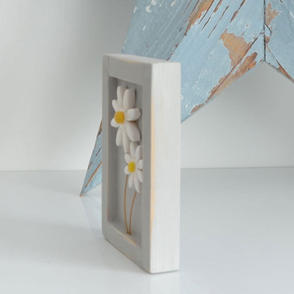 Miniature handmade wooden open frame in a distressed grey with two small clay white daisy flowers