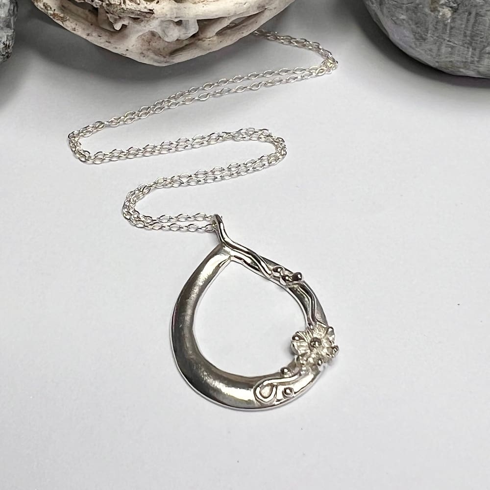 Silver teardrop necklace with flower detail