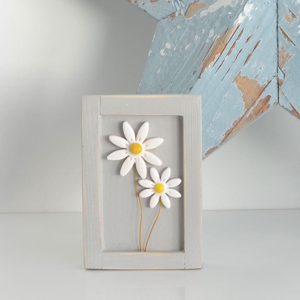 Miniature handmade wooden open frame in a distressed grey with two small clay white daisy flowers