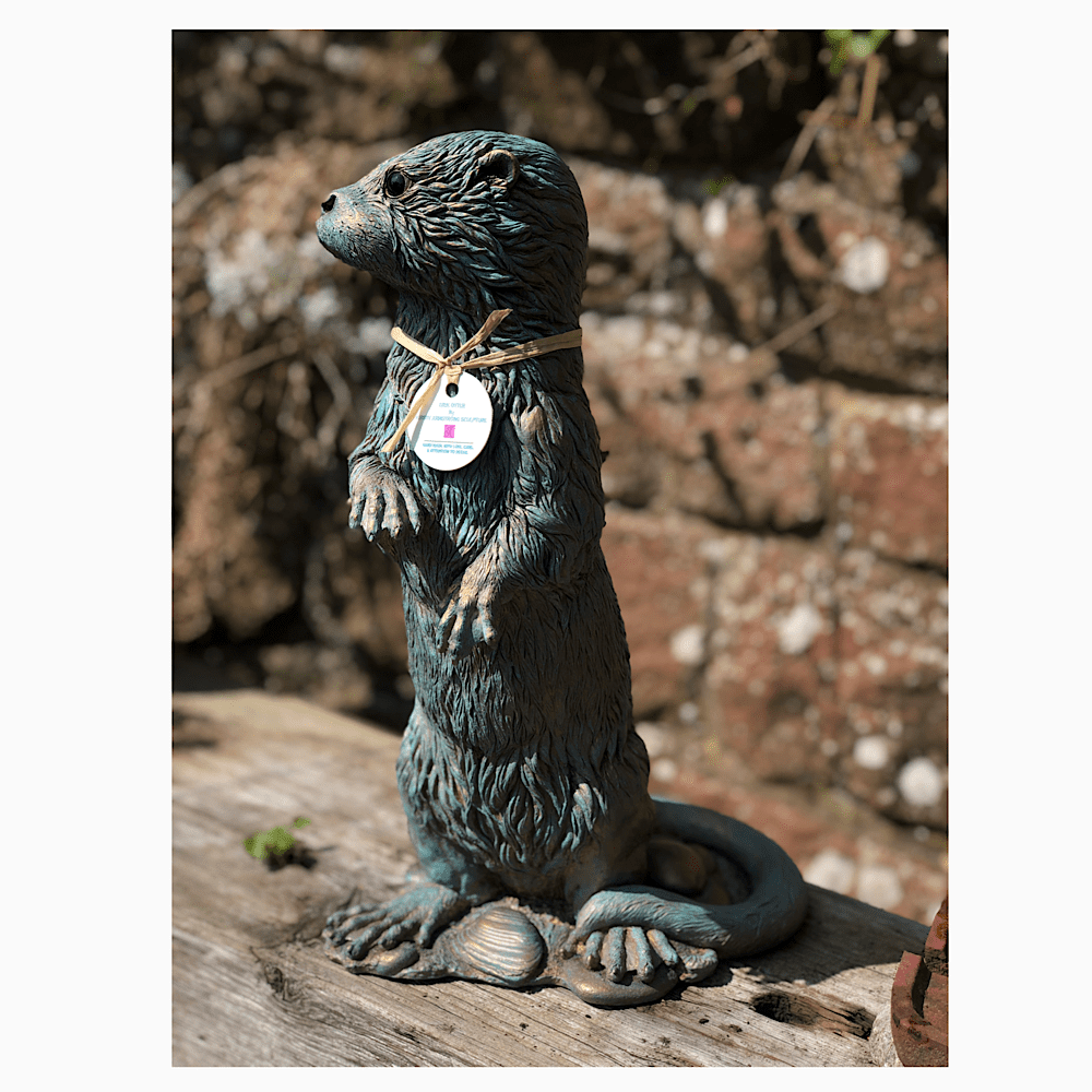 Young Otter sculpture with a weathered bronze and verdigris finish, by sculptor Kirsty Armstrong