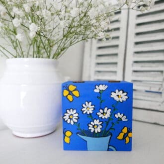 Blue jewellery box with white daisy flowers and yellow butterflies