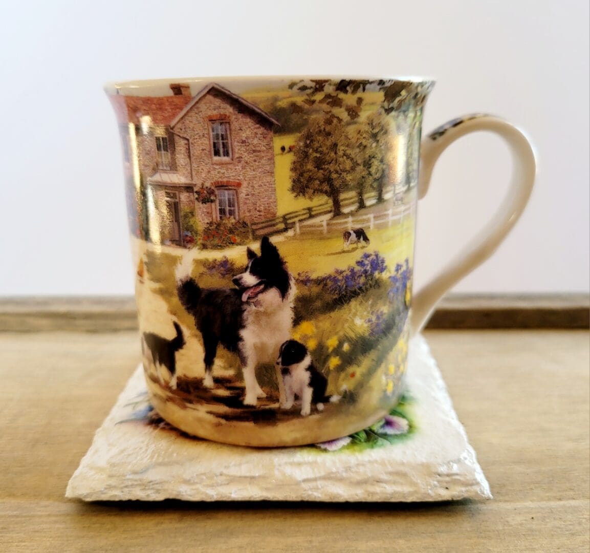 Border collie mug sitting on a white slate coaster