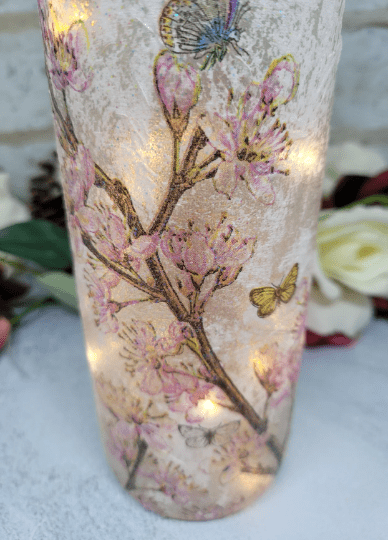 lit up standard wine bottle with flower butterfly design