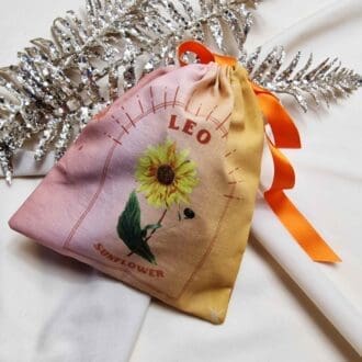 photo of a handmade cotton pouch with a digital print of the leo start sign and its birth flower, the sunflower