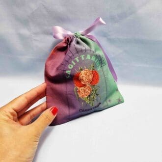 photo of a handmade cotton pouch with digital print of Sagittarius birth flower, carnation