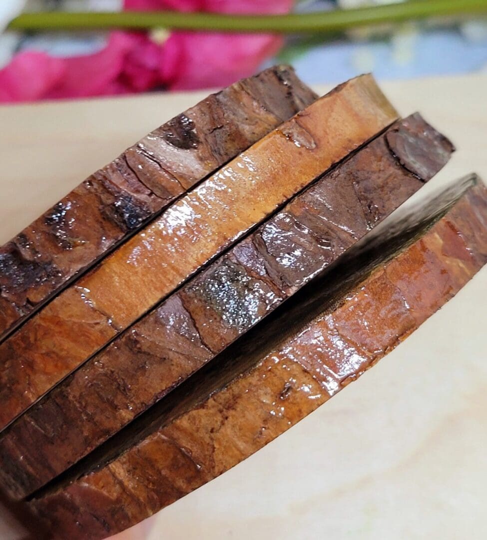 four round wood slice coasters showing the varnished bark