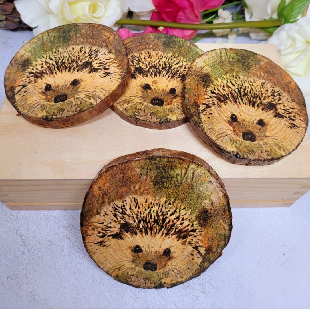 set of four round wood slice coasters, each with a hedgehog image