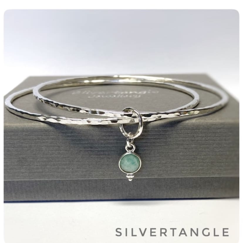 Two Hammered silver bangles joined with an Amazonite faceted charm.