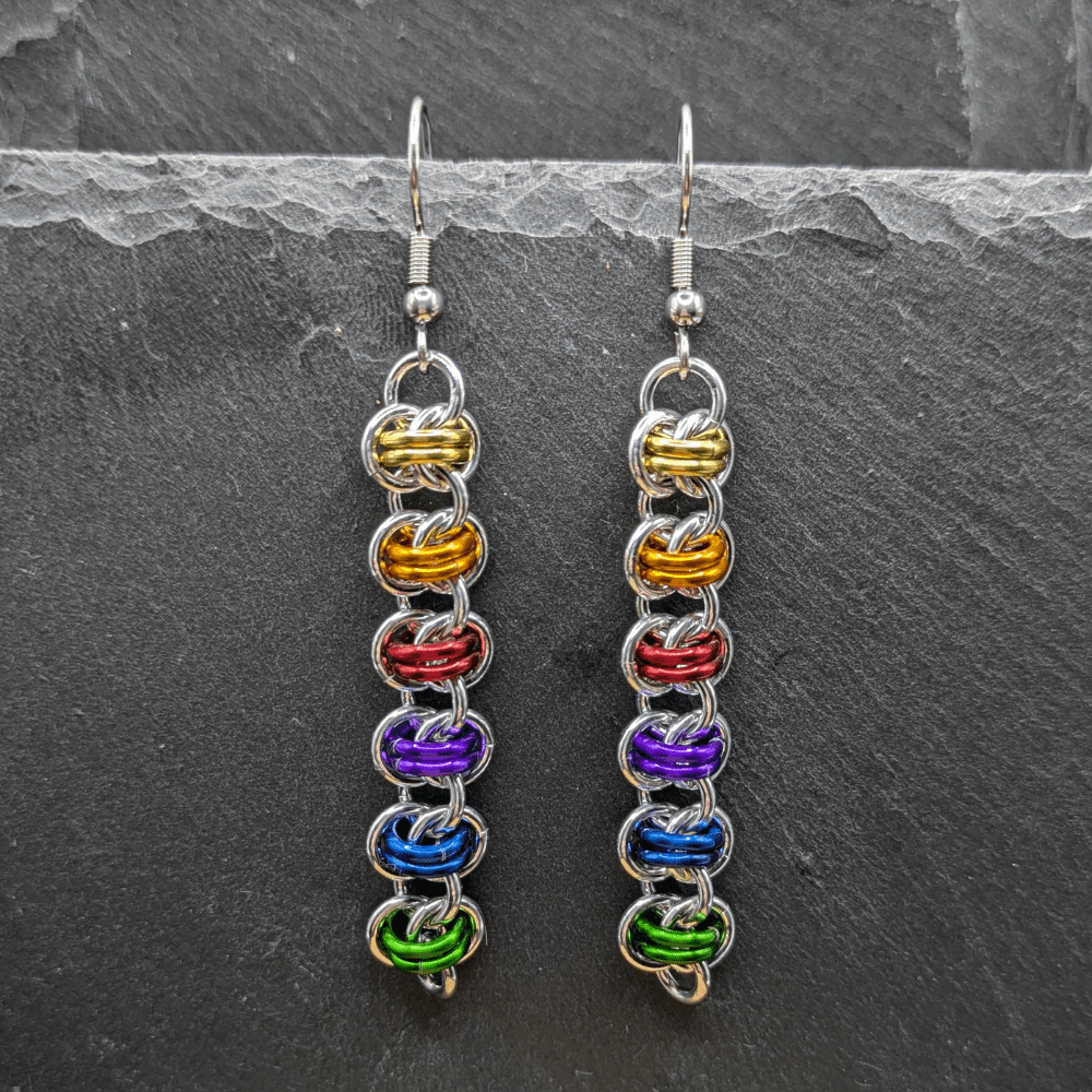 chainmaille earrings made in the barrel weave pattern using silver and rainbow coloured rings