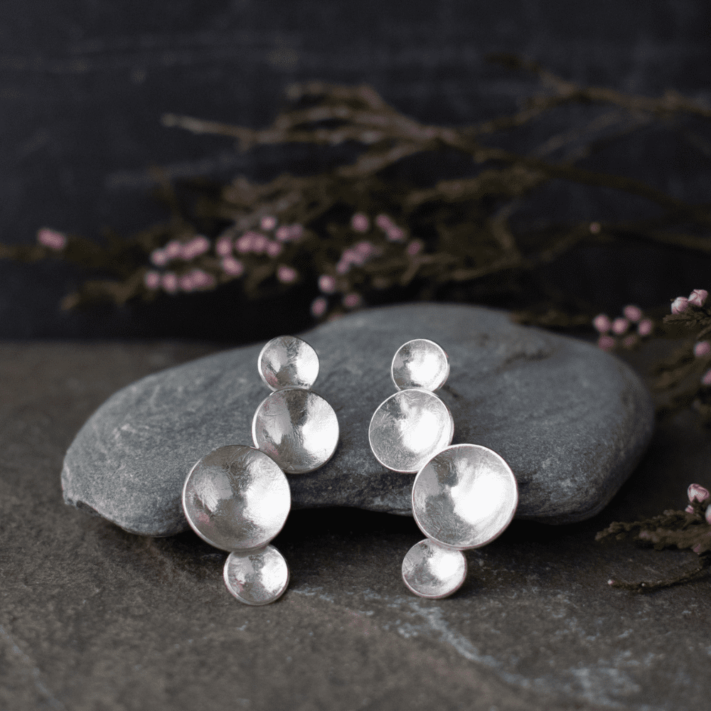 silver drop earrings with four domed circles of varying size