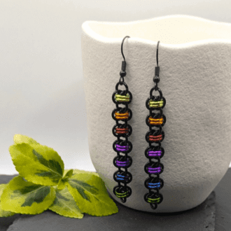 Chainmaille barrel weave earrings made with black and rainbow coloured rings