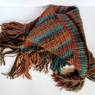 brown and blue striped poncho with long tassels