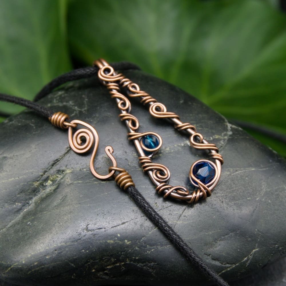 Copper wire pendant with blue beads and handmade fastenings by Oruki Design