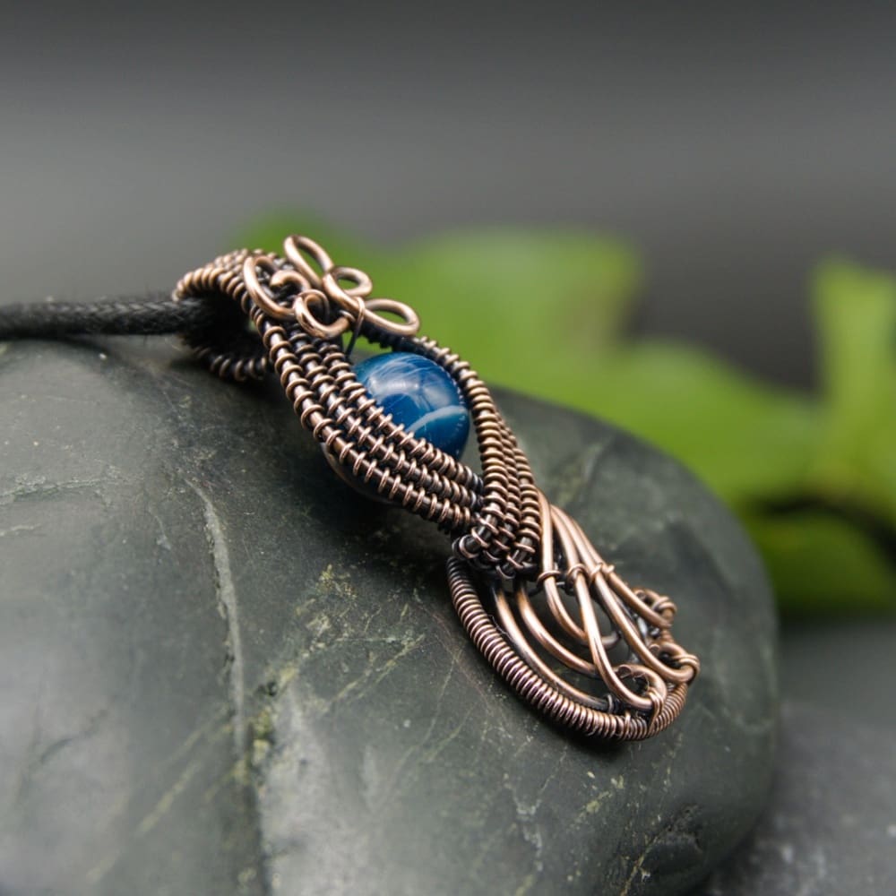 Copper wire woven figure of eight pendant with blue agate by Oruki Design