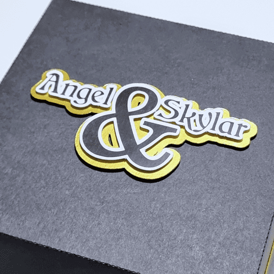 Lid panel of the Black & Gold Lapland Trip Reveal Exploding Box with the personalised names Angel & Skylar on it.