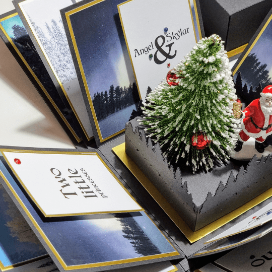 Black & gold Exploding Box for a surprise Lapland holiday focused on the four back panels that hold Christmas trip details and travel itineraries.