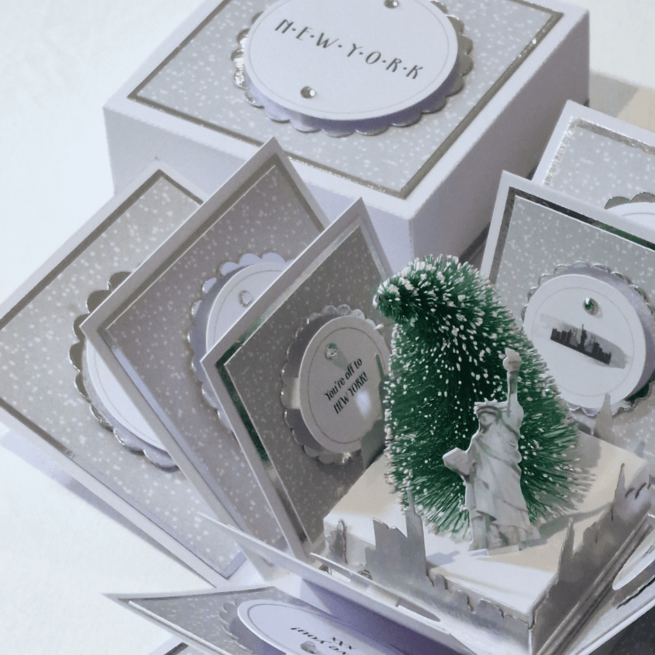 White & silver Christmas in new york exploding box open in close up view of centrepiece