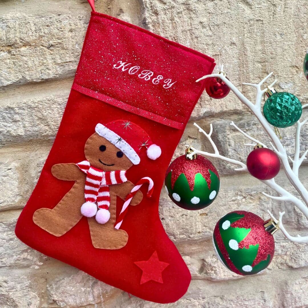 Christmas stocking featuring a gingerbread boy wearing a hat and scarf to keep warm