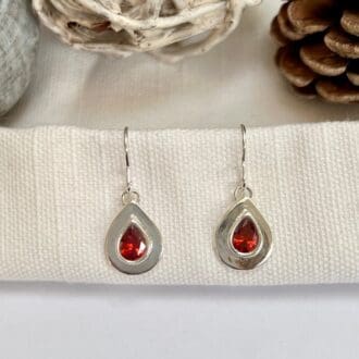 Handmade silver teardrop earrings set with garnet red cubic zirconia