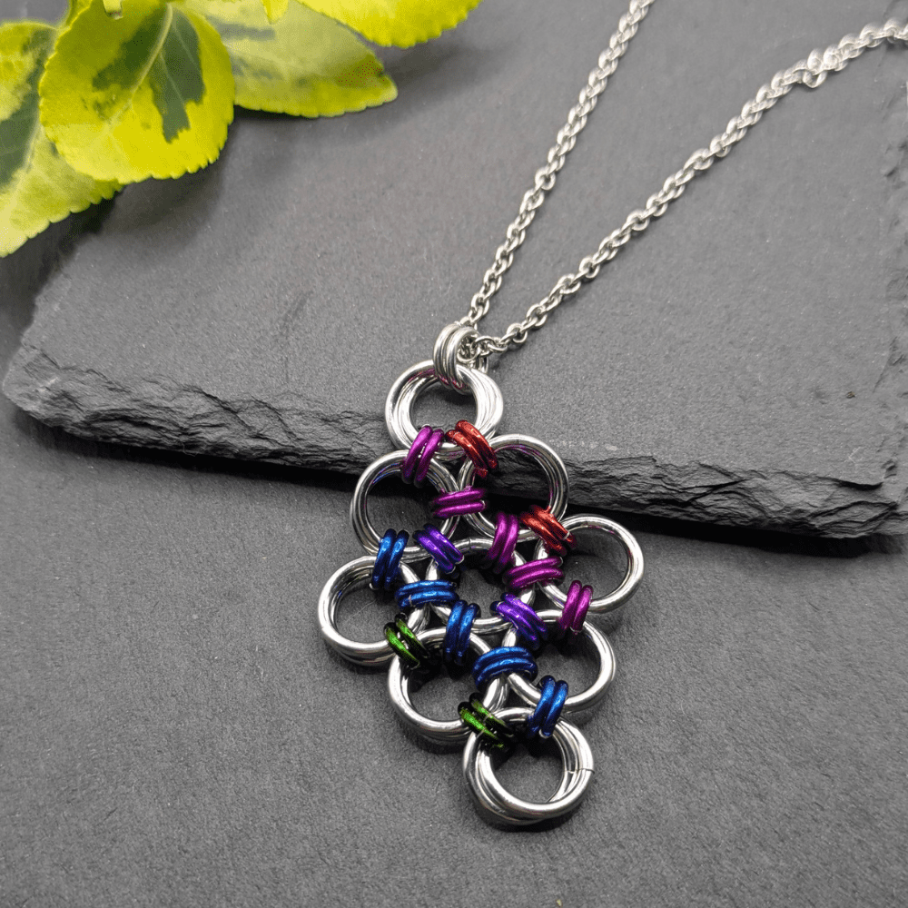 Chainmaille pendant made with aluminium rings in silver and bright colours. Woven in a diamond shape with the larger silver rings held together with smaller bright coloured rings