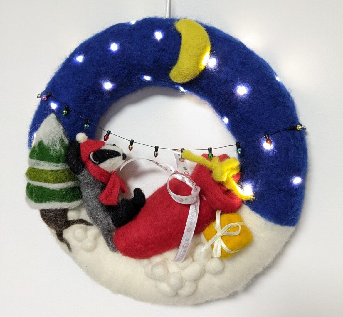 sleeping badger with red postage sack lit christmas wreath