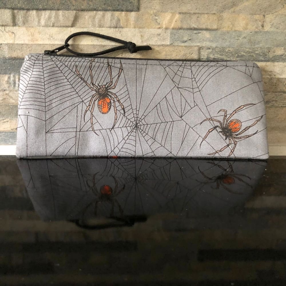 Pencil case or small make up bag in grey fabric featuring Halloween Spiders