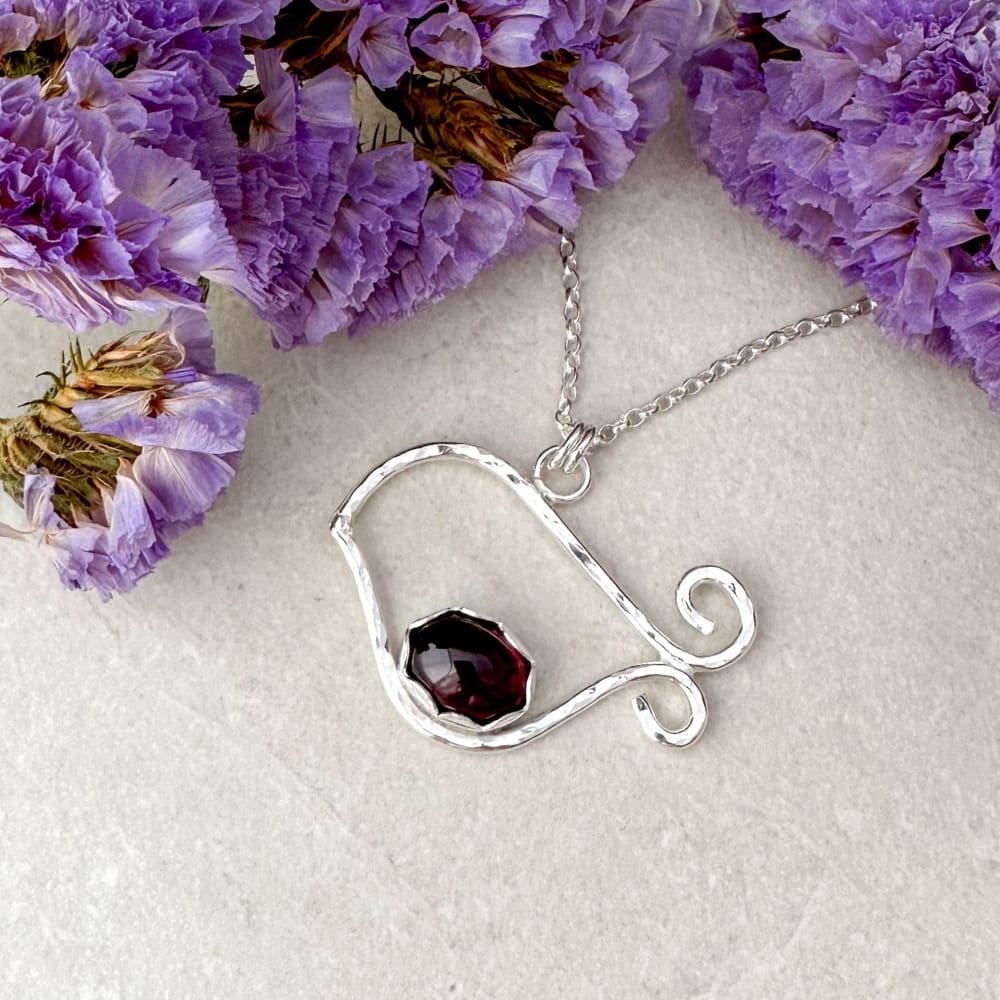 Silver robin bird necklace set with a red garnet gemstone