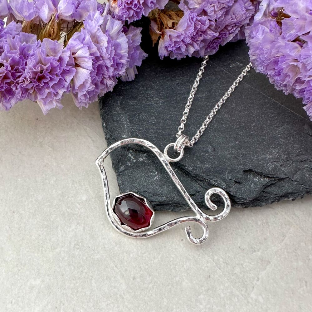 Silver robin bird necklace set with a red garnet gemstone