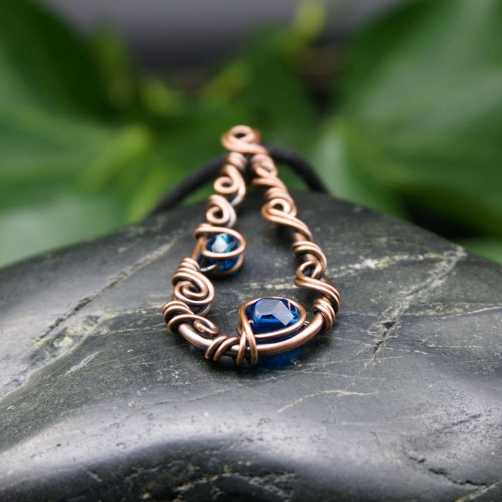 Simple wire wrapped copper pendant necklace in blue by Oruki Design