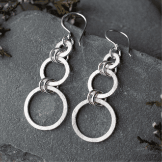 silver circle dangle earrings featuring three open circles of increasing size