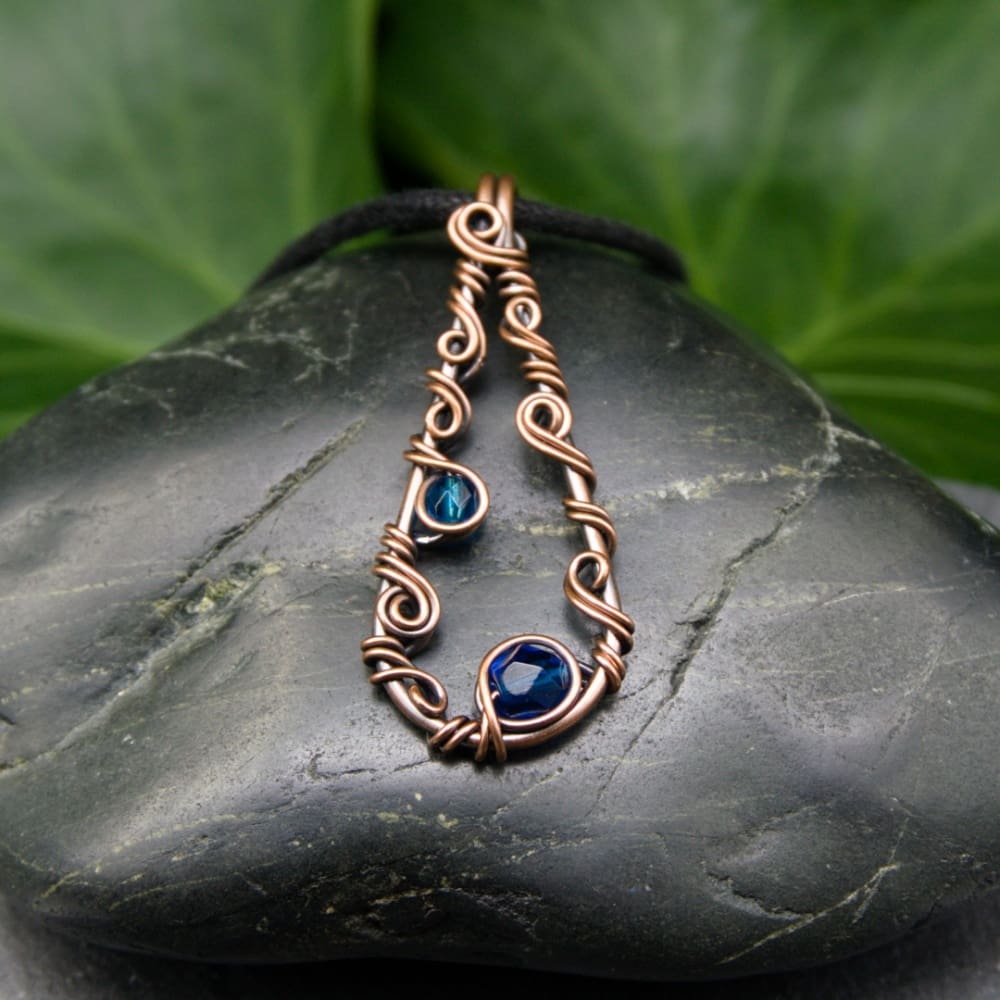 Wire wrap copper pendant necklace with blue faceted glass beads by Oruki Design