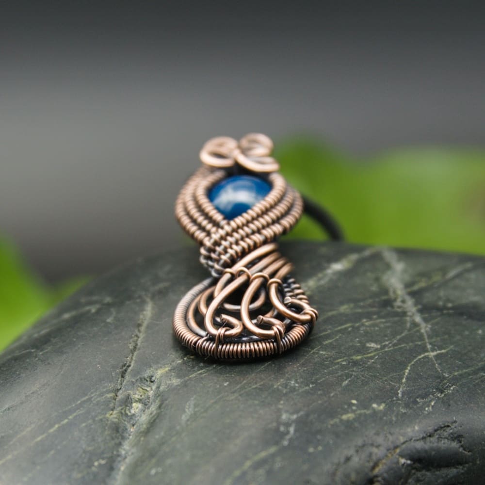 Wire wrapped figure of eight copper pendant in blue by Oruki Design