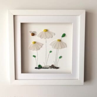 framed picture of three daisies made from Cornish sea glass