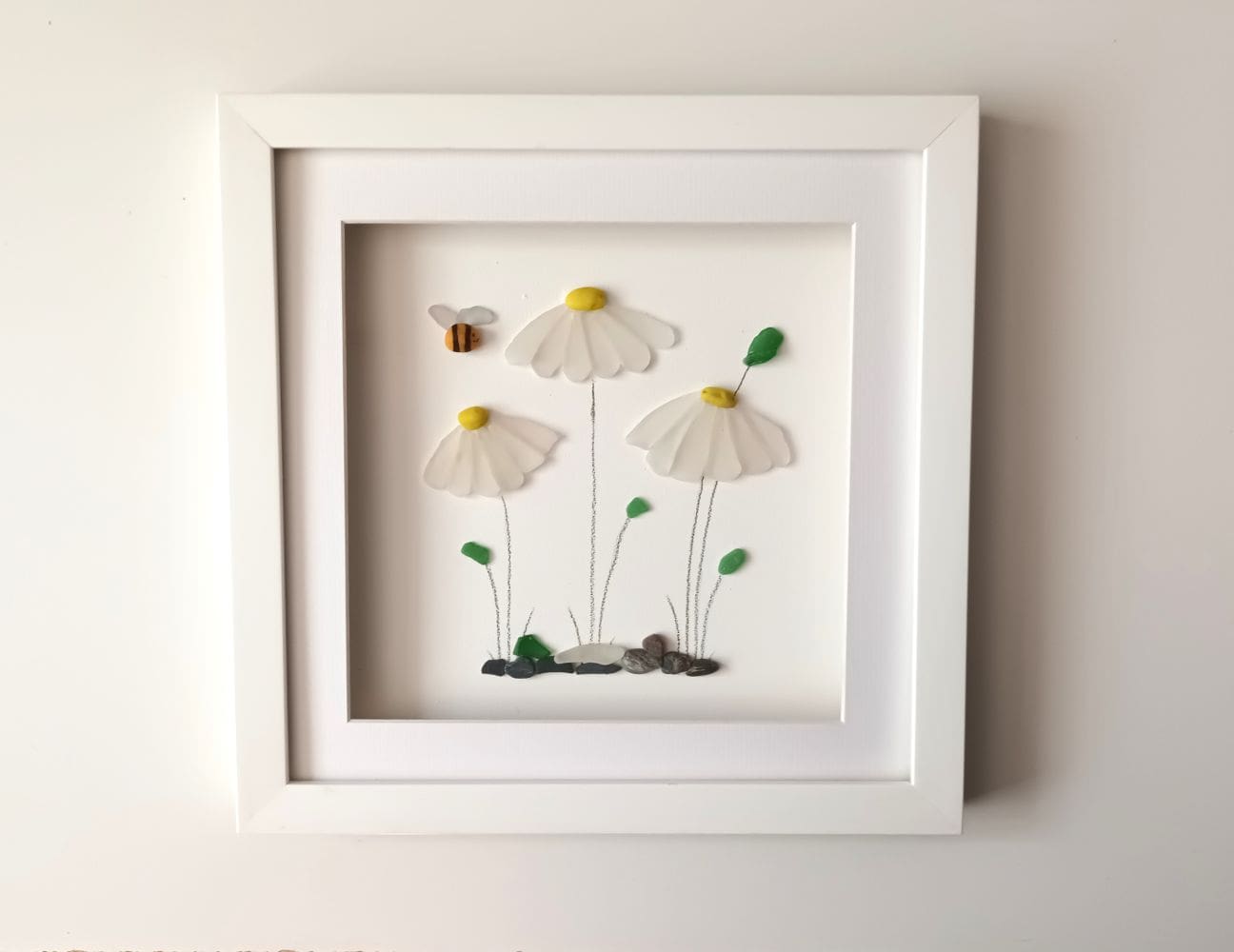 framed picture of three daisies made from Cornish sea glass